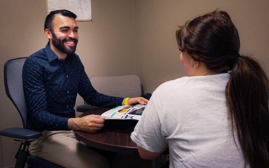 Abel Amezcua, a Roosevelt admission counselor who speaks Spanish and frequently works with prospective undocumented students and their parents