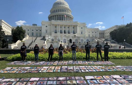 Student Samantha Latson photographs protestors at Capitol Hill with artwork depicting the many faces of gun violence.