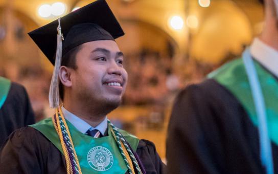 Smiling graduate in Auditorium