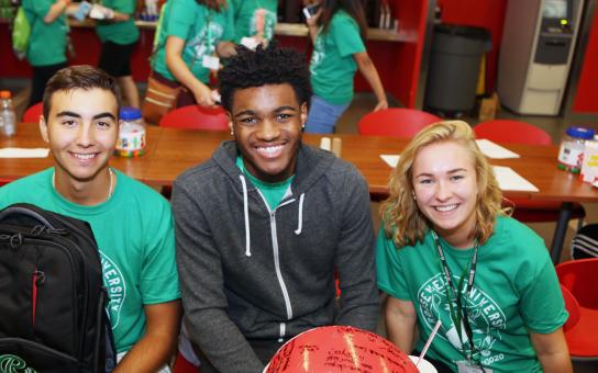 Three smiling students in RU t shirts - RU Inclusive