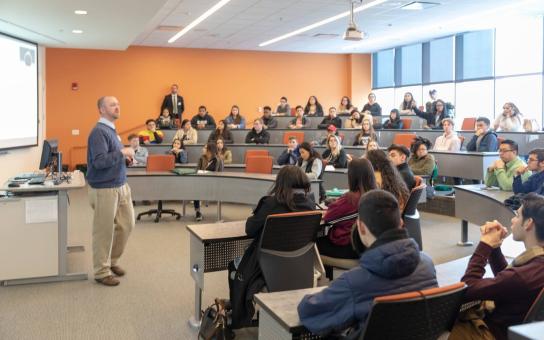 Lecturer in front of classroom full of students