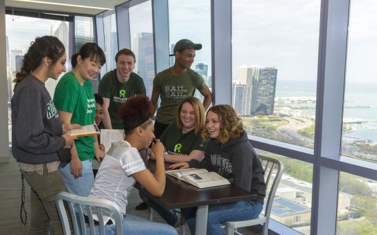 students at table in the Wbash Building, overlooking the lake