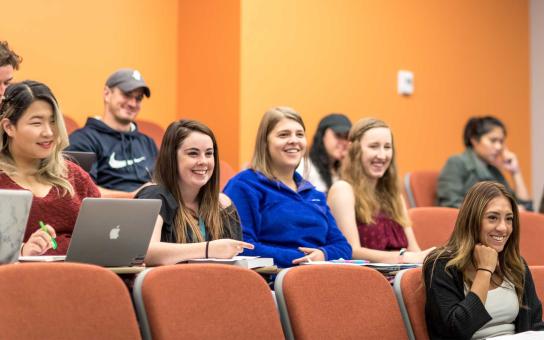 students smiling while listening to a lecture in a Wabash Building classroom