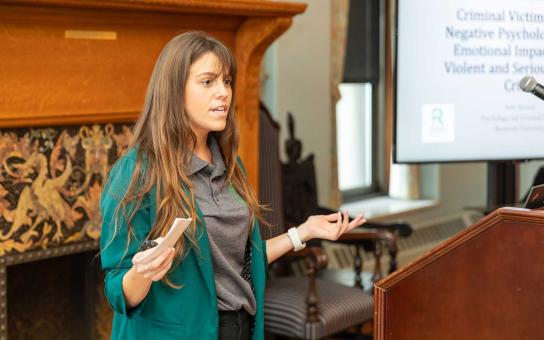 student presenting at a podium